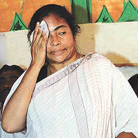 Ms Mamata Banerjee, chief of the Trinamool Congress, wipes her forehead during her first public appearance after being trounced by the Left Front in elections in Kolkata on Monday.