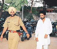 Rajwinder Singh, a prime suspect in the murder of a 60-year-old woman, being taken to the court of Judicial Magistrate, Kharar, on Wednesday. 