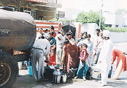 Residents gather to get water from a tanker provided by the local administration in Kalka on Wednesday. 