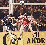 Dario Marra (L) of Argentine soccer club Rosario Central jumps for the ball with Nicolas Tagliani of Chile's Cobreloa during their Libertadores Cup clash on Tuesday. 