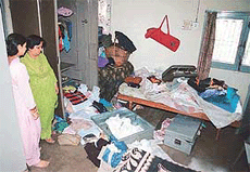 Mrs Verma inspects the ransacked room at her Sector 22 house after it was burgled in the morning in Chandigarh on Thursday.