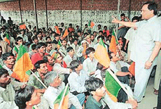 Mr Dharam Paul Gupta President of the local unit of the BJP, tries to pacify agitating Kabari Market Labour Colony residents who gheraoed him at the party office in Chandigarh on Thursday.