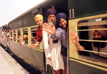 Sikh yatrees wave to people when their special train entered Pakistan at the Wagah border to the east of Lahore on Friday.