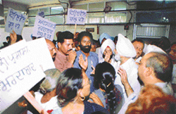 City Mayor Apinder Singh Grewal tries to pacify irate residents, protesting against poor water supply and �partisan� attitude of the MC authorities, outside the meeting hall of the MC in Ludhiana on Friday. 