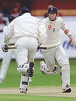 England opening batsman Michael Atherton (R) runs between the wicket with partner Marcus Trescothick (L) during the second day of the first test against Pakistan at Lords  on Friday.