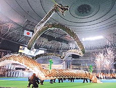 A dragon floats in the air as fireworks explode during the opening ceremony of the third East Asian Games in Osaka, Japan on Saturday. 