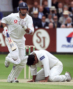 England captain Nasser Hussain runs past a dejected Akhtar during the third day of the first Test against Pakistan at the Lords in London on Saturday.
