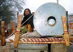 A woman sits with her belongings
