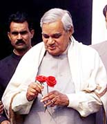 Prime Minister Atal Behari Vajpayee with a pair of roses in his hands given by well-wishers on New Year�s Day at his residence in New Delhi on Tuesday.