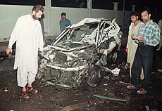 Pakistani officials investigate after a bomb exploded in Karachi early on Tuesday. 