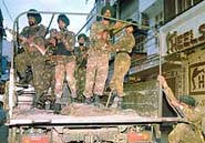 Army men patrol a street in central Jammu