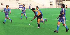 Neelam of Delhi, who scored eight goals against Mizoram, takes possession of the ball in the eighth Nehru-NDMC Girls Hockey Tournament at the Shivaji Stadium in the Capital on Friday. Delhi won by 11-0.