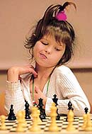 Six-year-old Vaiva Palunas fidgets as she contemplates her next move