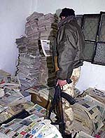 A Palestinian policeman inspects the offices of the Hamas-sponsored newspaper Hebron Times after the Palestinian Authority ordered its closure, in the West bank town of Dora, outside Hebron, early on Friday.