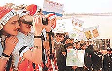 Students scan the horizon for migratory birds during an on-the-spot painting competition held at Sukhna Lake in Chandigarh on Saturday.