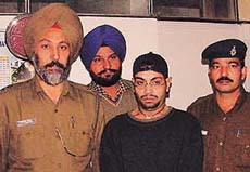 Harpreet Singh Ahuja, alias Ajay Andley, in police custody on the charge of posing as TV serial director in Chandigarh on Wednesday.