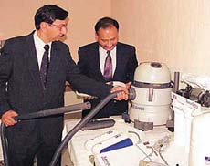Harish Verma (left) MD of NUVAC shows his product at a press conference in Chandigarh on Wednesday.