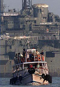 A passenger ferry goes past "Indian Museum Ship�Vikrant"