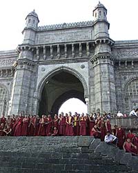 Indian Buddhist tourists from Kashmir stand in front of the Gateway of India