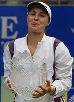 Switzerland's Martina Hingis reacts as she holds her trophy