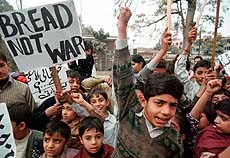 Pakistani children display a placard during a peace rally