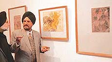 Sculptor Shiv Singh interacts with Ajaib Chitrakar at the latter�s art exhibition in Punjab Kala Bhavan, Chandigarh, on Tuesday.