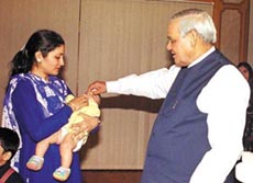 The Prime Minister, Mr Atal Behari Vajpayee, giving pulse polio drops to a baby during a countrywide immunisation campaign.