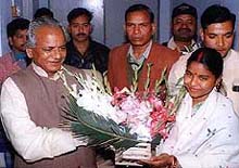 Former Uttar Pradesh Chief Minister and Rashtriya Kranti Party chief Kalyan Singh greets his party candidate