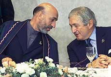 Afghan leader Hamid Karzai talks with World Bank President James Wolfensohn (right) at a dinner hosted by the letters in Tokyo on Monday. The World Bank proposed $500 million in assistance for war-ravaged Afganistan over the next 30 months.