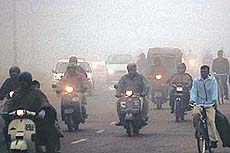 Foggy morning: City residents drive through a thick curtain of fog in Chandigarh on Tuesday morning.