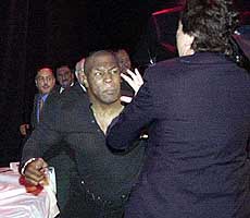 Mike Tyson punches a bodyguard.