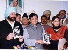 Punjab Congress Chief Capt. Amarinder Singh and senior party leader, Ahmed Patel releasing a chargesheet enlisting "Non performance and misdeeds" of Akali-BJP combine government in Chandigarh on Thursday. 