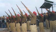 A contingent of the Punjab Police fires in the air in honour of the minister at the cremation on Friday at Kotbhai village.