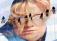 The Rapid Descent window washing crew applies the finishing touches to a giant photo