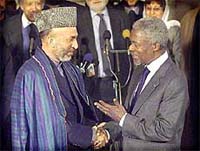 Afghanistan's Interim Prime Minister Hamid Karzai, left, shakes hands with U.N. Secretary General 