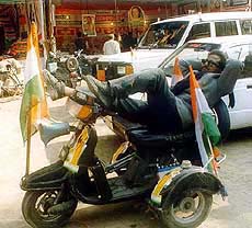 A congress worker taking a  nap on his scooter
