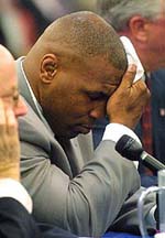 Mike Tyson wipes the sweat from his brow while appearing before the Nevada State Athletic Commission in Las Vegas on Tuesday.