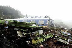 A man walks at the crash site of the Ecuadorean Tame Boeing-727 jetliner 