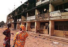 Two wives of Nigerian army officers view a building in the army barracks of the Ikeja military cantonment in Lagos