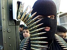 A Palestinian gunman takes part in a symbolic funeral procession for Wafa Idres from Al-Amari refugee camp near Ramallah on Thursday.