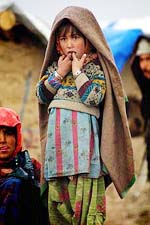 An Afghan girl watches the goings on at the Maslakh refugee camp