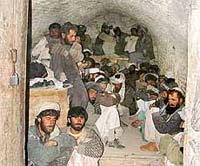 Afghan fighters loyal to the interim government sit in a prison in the town of Gardez