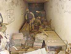 During a search and destroy mission, US Navy SEALs discover a large cache of munitions in one of more than 50 caves explored in the Zhawar Kili area
