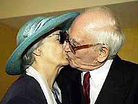 Madeleine Francineau, left, and Francois Fernandez, give each other a kiss shortly after they got married 