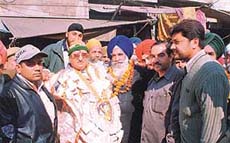 The BJP candidate from Ludhiana East, Mr Sat Pal Gosian, with his supporters during a door-to-door campaign in Ludhiana on Monday.