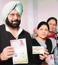 Capt Amarinder Singh shows the Congress manifesto at a function in Patiala.