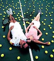 Two tennis players rest after playing 