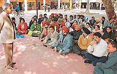 Members of the Punjab and Chandigarh College Teachers Union hold a protest rally outside the office of DPI (Colleges), Punjab, in Sector 17, Chandigarh, on Wednesday.