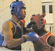 Ajay Singh of Chandigarh (Red) outguns P.Gol Chand of Manipur in the Light Middle Weight of the National Boxing Championship at YMCA in the Capital on Wednesday.