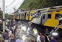 Rescue workers search through the wreckage of a passenger train